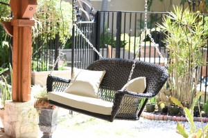 Espresso Resin Wicker Porch Swing with Ivory Cushion