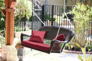 Espresso Resin Wicker Porch Swing with Red Cushion