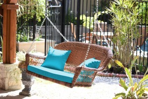 Honey Resin Wicker Porch Swing with Sky Blue Cushion