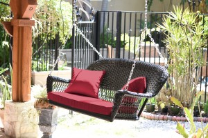 Black Resin Wicker Porch Swing with Red Cushion
